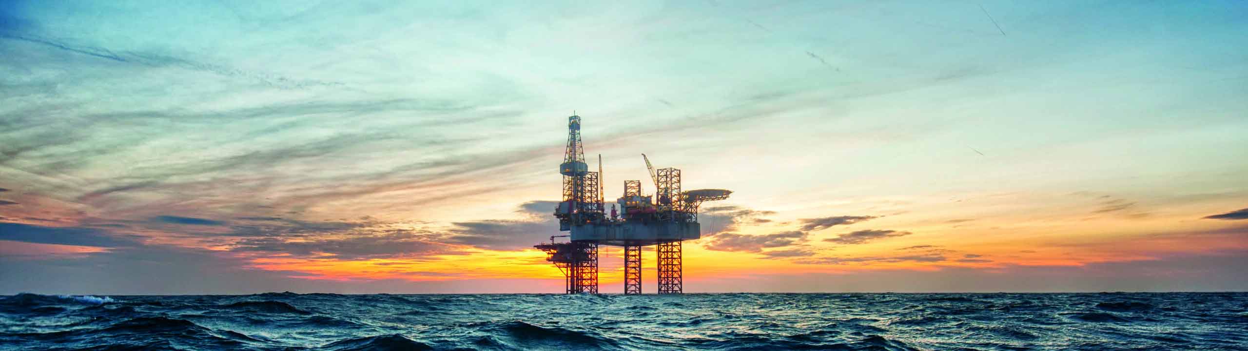 Offshore Anlage vor Sonnenuntergang, Wasser im Vordergrund